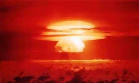 Bright orange mushroom cloud rising over a dark, clouded horizon